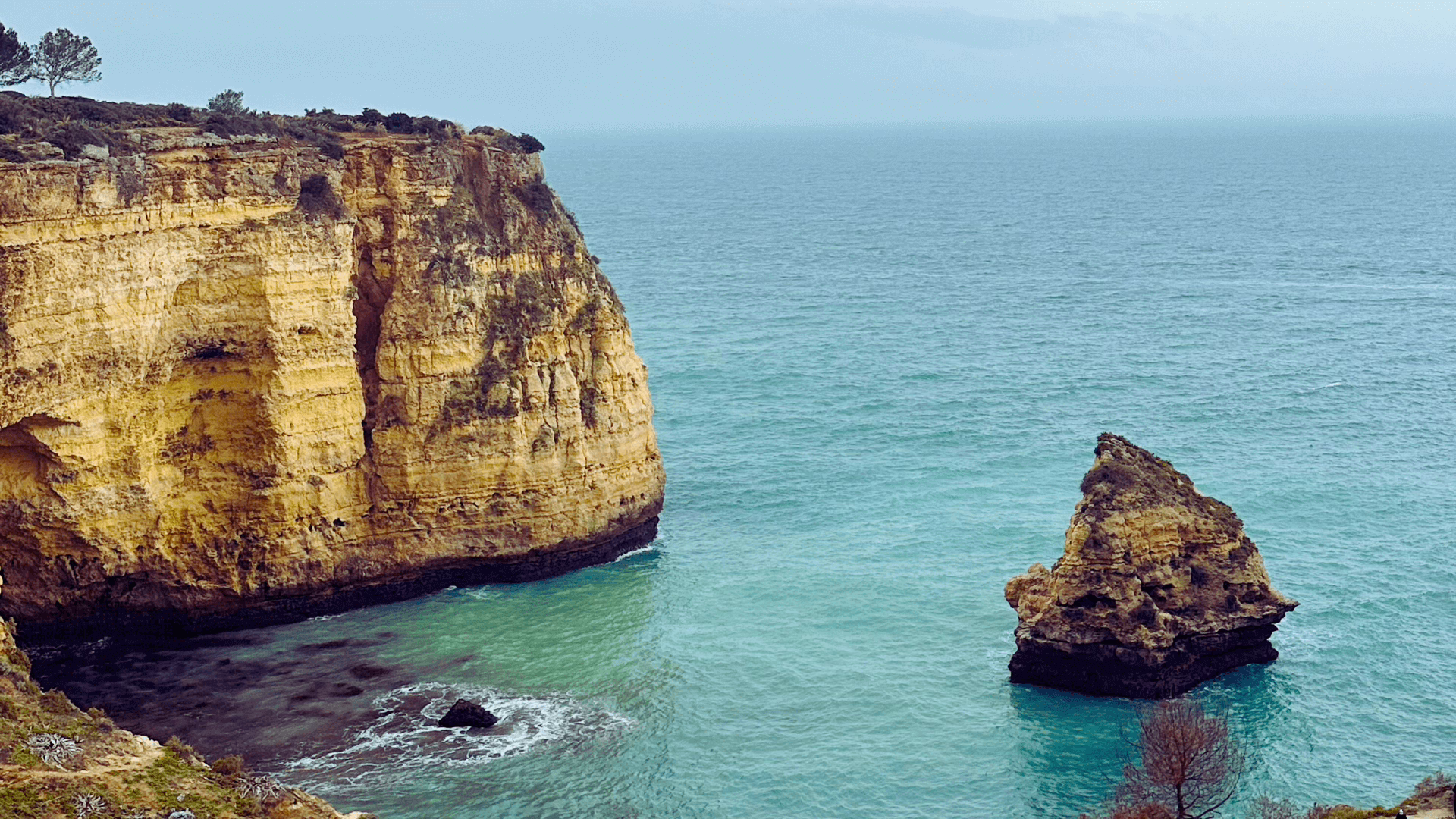 Big cliff against the Atlantic Ocean in Algarve Portugal