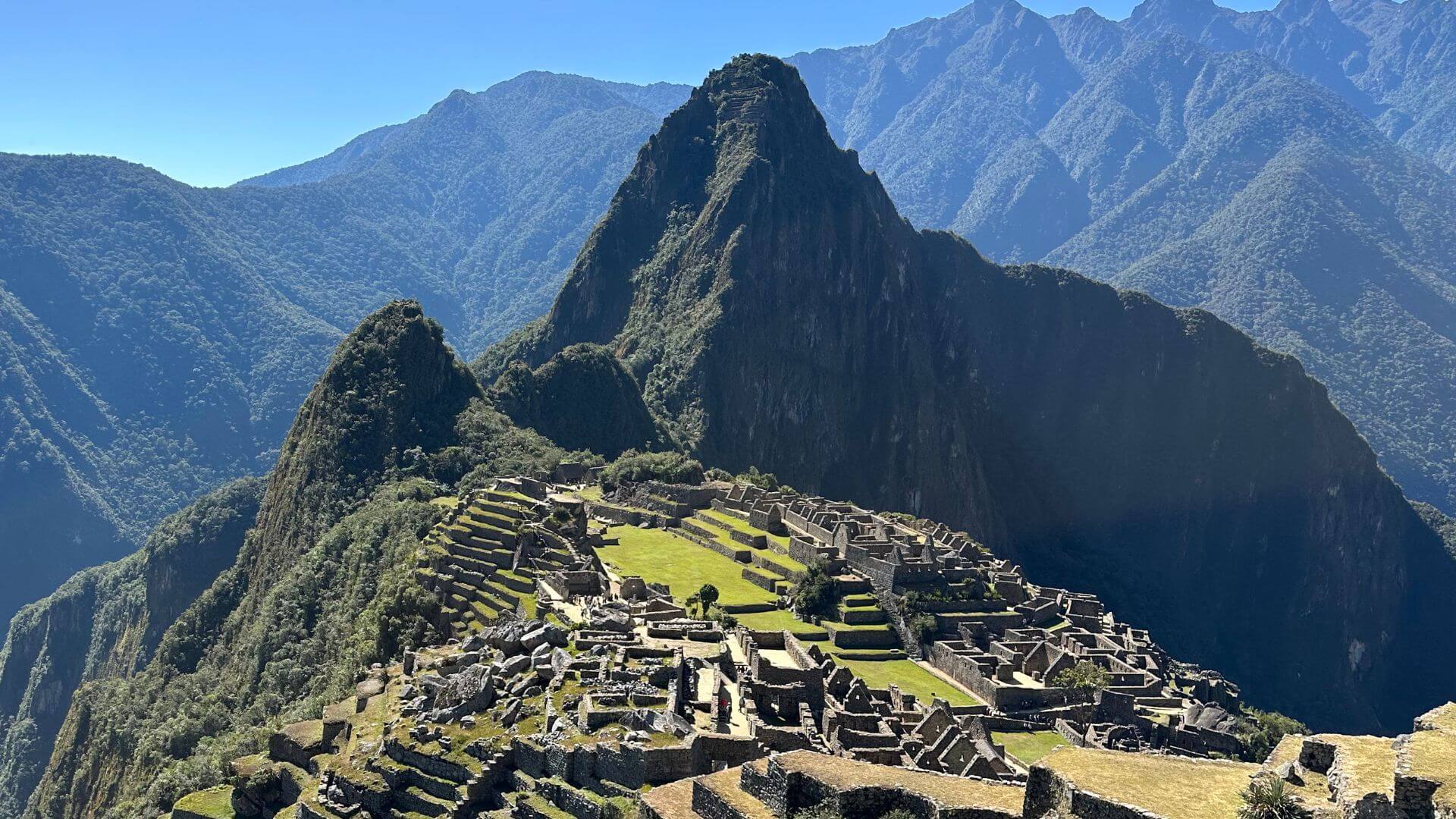 Panoramic view of Machu Picchu ruins surrounded by Andes Mountains