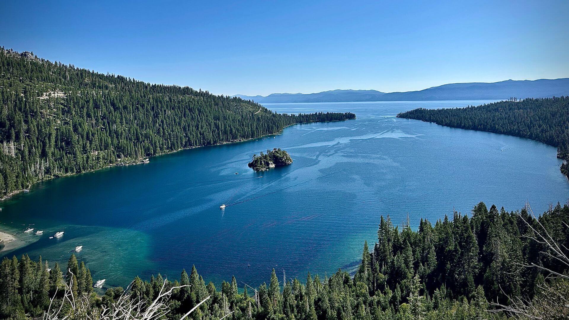 Lake Tahoe with the mountains and boats sailing in the lake.